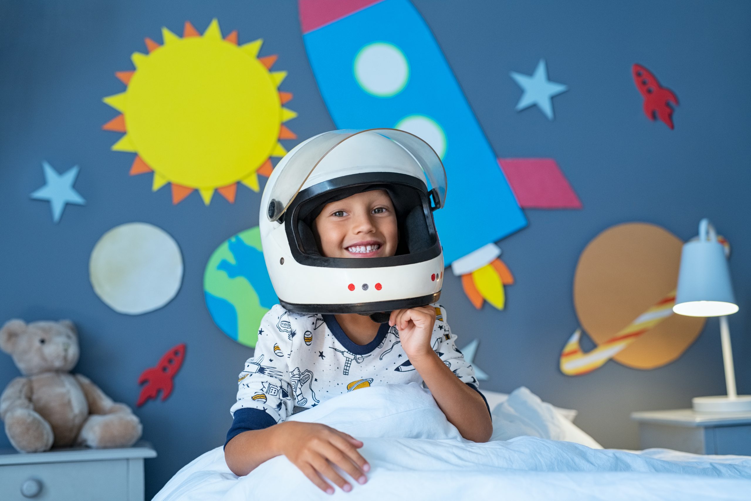 Image: Kid smiling playing astronaut | Pediatric Dental Center of Tampa - Dental Services & Procedures